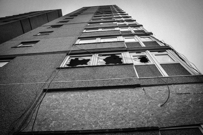 The buildings take on a new sadness with broken windows. 